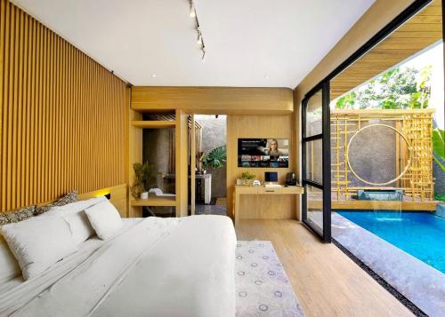 a bedroom with a large bed and a swimming pool at Akaya Villas Solo in Kemiri