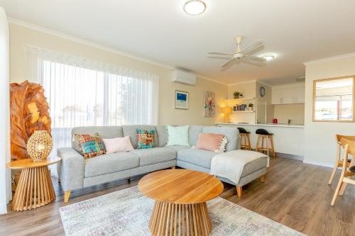 a living room with a couch and a table at Mariners Cove at Paynesville in Paynesville