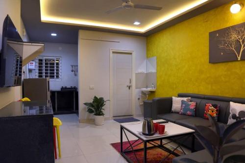 ハイデラバードにある8 MidTown-1BHK, Near AIG Hospital, Hitech Cityのソファとテーブルのあるリビングルーム
