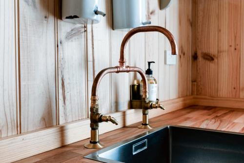 a kitchen sink with a copper faucet at Rustic Barn by the Bay in Low Head