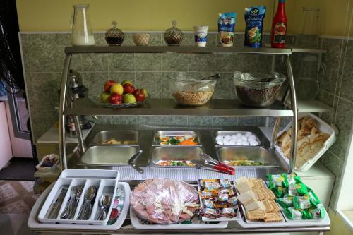an open refrigerator filled with lots of food at Diamond Hotel Dushanbe in Dushanbe