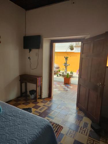 a bedroom with a door leading to a courtyard at Hotel Francisco's la Merced in Antigua Guatemala
