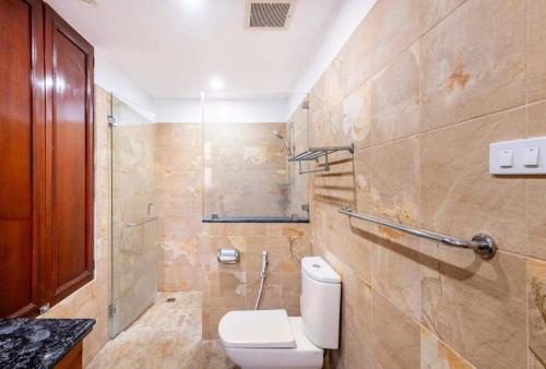 a bathroom with a white toilet and a shower at Casa Monk in Nasugbu