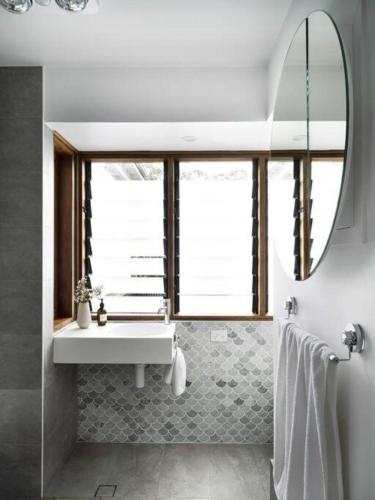 a bathroom with a sink and a mirror at Jamberoo Valley Farm in Jamberoo