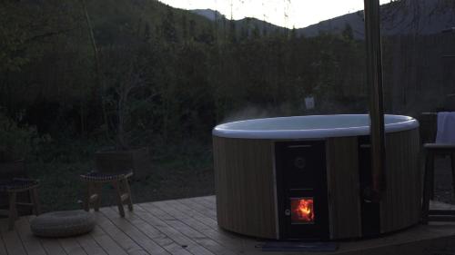 a fire pit with a fire in it on a patio at Les Gites du Fesquet - agréable T2 indépendant dans cadre calme et verdoyant in Cazilhac