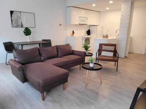 a living room with a couch and chairs and a kitchen at 629 Lofts 810 - A KCM Property in Cleveland
