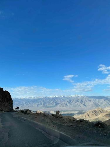 a road in the desert with mountains in the background at The Kesar Guest House Sumoor in Leh
