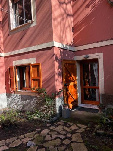 a pink building with a door and windows at La Casetta in Moneglia