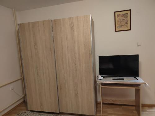 a large wooden cabinet with a television on a table at Mária in Košice