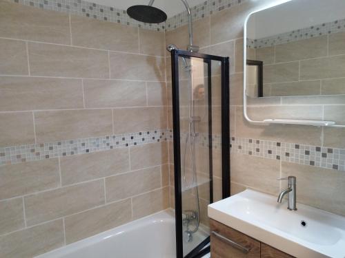 uma casa de banho com um chuveiro e um lavatório. em Charmant T2 RD jardin grande terrasse coeur ville plage 2 m clim garage wifi em Sainte-Maxime