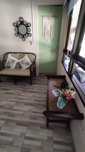 a room with a bed and a table with flowers on it at Baan sikhao Yanui in Rawai Beach