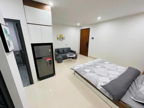 a bedroom with a bed and a couch in it at FlowerGod Apartments - BlackPink HomeStay in Hanoi