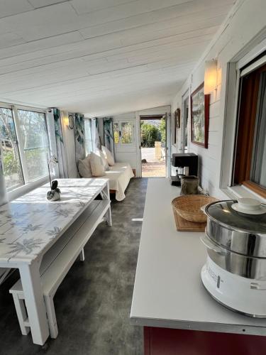 a kitchen and living room with a table and a barrel at BUNGALOW 60 M2 in Roquebrune-sur-Argens