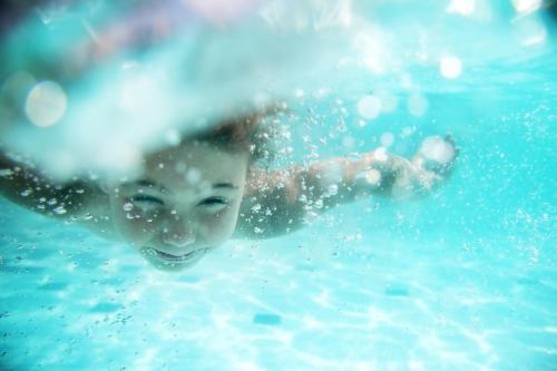 a young boy swimming in a swimming pool at Van der Valk Theaterhotel Almelo in Almelo