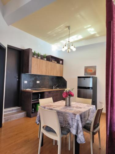 a kitchen and dining room with a table and chairs at Apartments Kimm II in Poreč