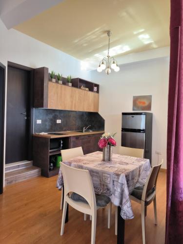 a kitchen and dining room with a table and chairs at Apartments Kimm II in Poreč