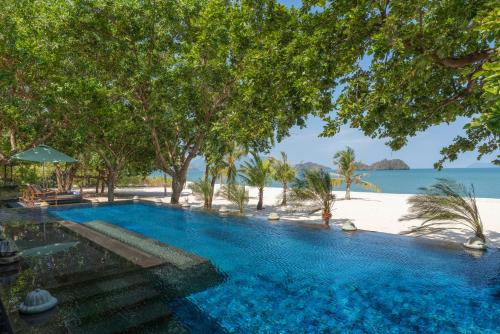 a swimming pool with a view of the beach at Four Seasons Resort Langkawi in Tanjung Rhu