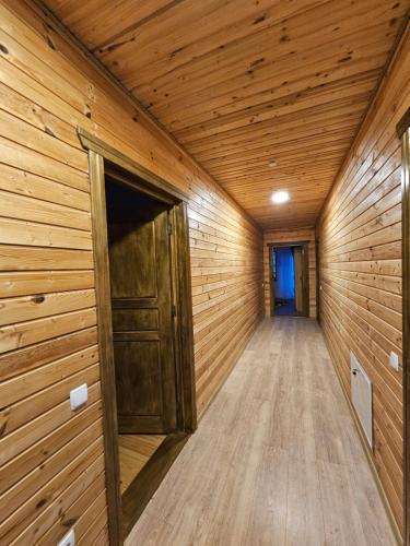 a sauna with wooden walls and a wooden door at Pensiunea Ana Maria Durau in Durau