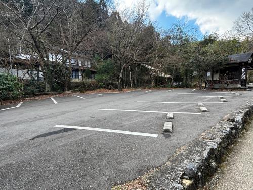 an empty parking lot with birds sitting in it at Kyo no Minshuku Ohara no Sato in Kyoto