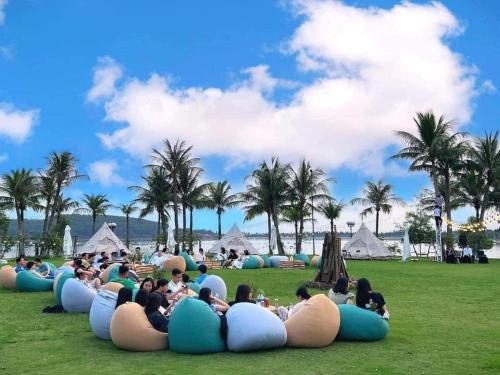 a group of people laying on the grass in inflatables at Villa Owner tại khu nghỉ dưỡng sinh thái Đại Lải Resort in Ngọc Quang