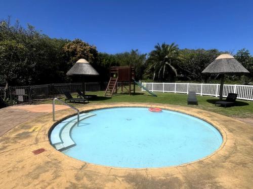 a small swimming pool with a playground and a swing at Pinnacle Lodge 1089 in Dana Bay