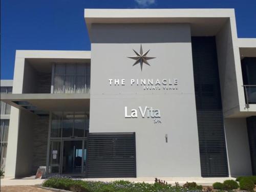 a building with a sign that reads the plunge la vita at Pinnacle Lodge 1089 in Dana Bay