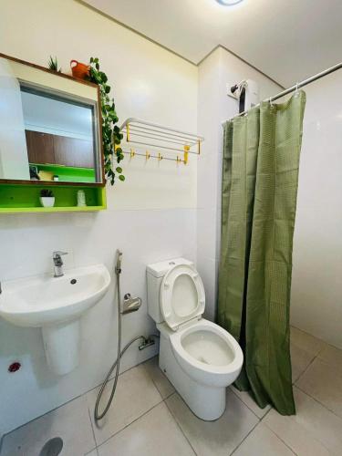 a bathroom with a white toilet and a sink at Studio 7 in Manila