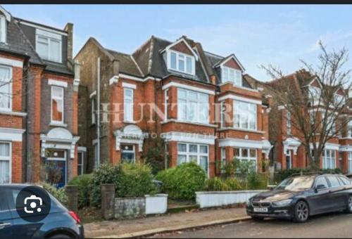a car parked in front of a row of houses at Centrel to london single bed room quiet home with host and breakfast in London
