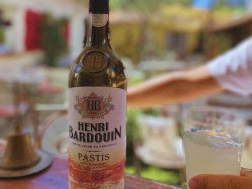 a bottle of wine sitting on a table with a glass at La Jabotte in Antibes