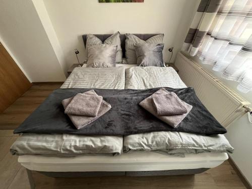 a bed with pillows on it in a bedroom at Ferienhaus Deutschmann Sankt Lambrecht in Sankt Lambrecht