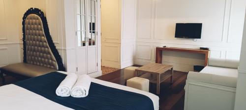 Télévision ou salle de divertissement dans l'établissement Grand Hotel Urban