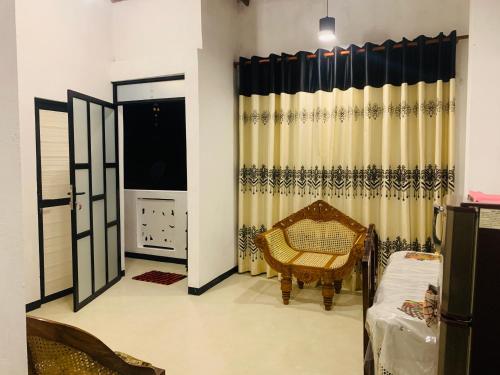 a living room with a bed and a window at Shehan Villa in Beruwala