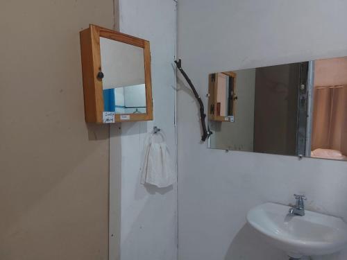 a bathroom with a sink and a mirror at Hostal Brisas del Ometepe Habitación 2 in Rivas
