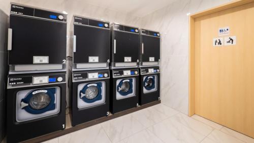 a row of washing machines in a laundry room at Toyoko Inn Gotemba Ekimae in Gotemba