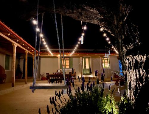 a patio at night with lights on a house at Lichada Villas in Likhás