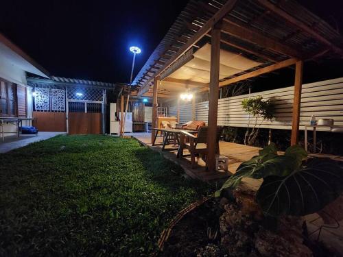 a porch of a house at night with a table at MamaTang Poolvilla - มามาแตง พูล in Ban Nong Khong