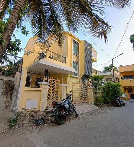 a motorcycle parked in front of a yellow house at CityAir in Pune