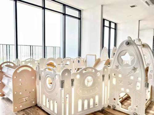 a nursery with white furniture and large windows at Jeff & Ricky Homestay102@ The Podium in Maong Bazaar