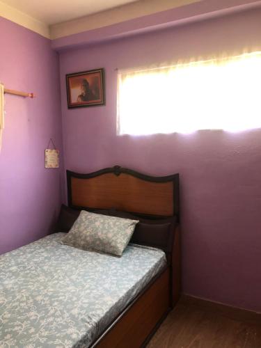 een kleine slaapkamer met een bed en een raam bij Diamond Home Stay - Private Rooms in Kathmandu