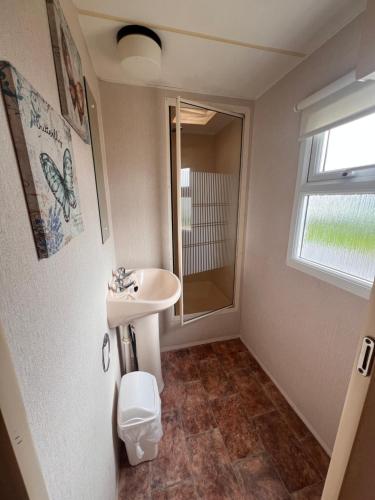 a bathroom with a sink and a shower at AMS Caravan Holidays in Ingoldmells