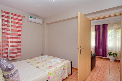 a bedroom with a bed and a sliding door at Τhalassa Home Fine Living in Petra