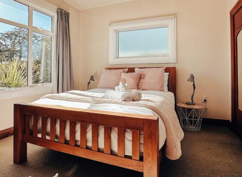 a bedroom with a bed with a teddy bear on it at Hokitika Beach Break in Hokitika