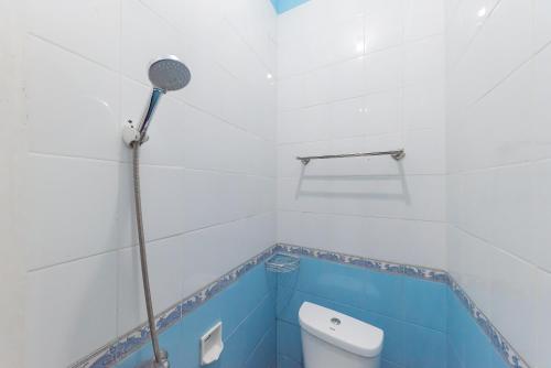 a bathroom with a toilet and a shower at RedDoorz Syariah near Alun Alun Sumedang in Sumedang