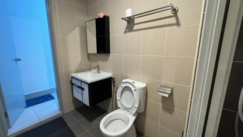 a small bathroom with a toilet and a sink at HH KL Prime location Residence near TRX in Kuala Lumpur