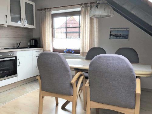 a kitchen with a dining room table and chairs at Haus Margret in Carolinensiel