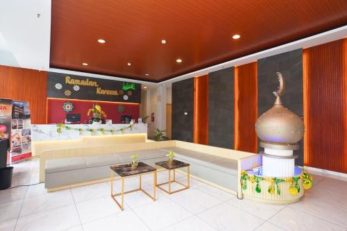 a store lobby with a couch and tables in it at Front One Hotel Pasir Koja Bandung in Bandung