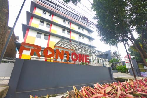 a building with a sign in front of it at Front One Hotel Pasir Koja Bandung in Bandung