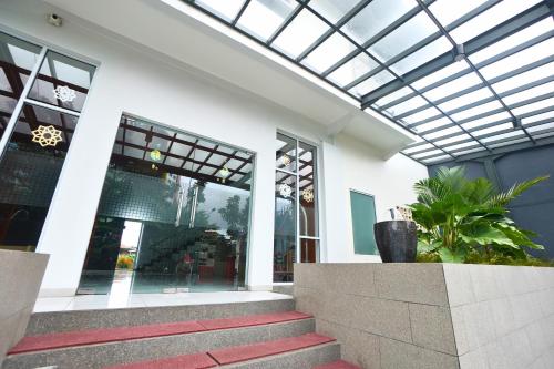 a building with a glass ceiling and stairs in front at Front One Hotel Pasir Koja Bandung in Bandung