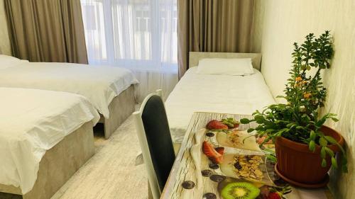 a hospital room with two beds and a table with fruit on it at Guest house Roza in Kazarman