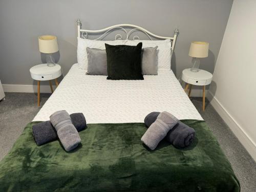 a bed with two pairs of mitts on it at Harbourside Apartment - 1 Bed Apartment in Whitehaven